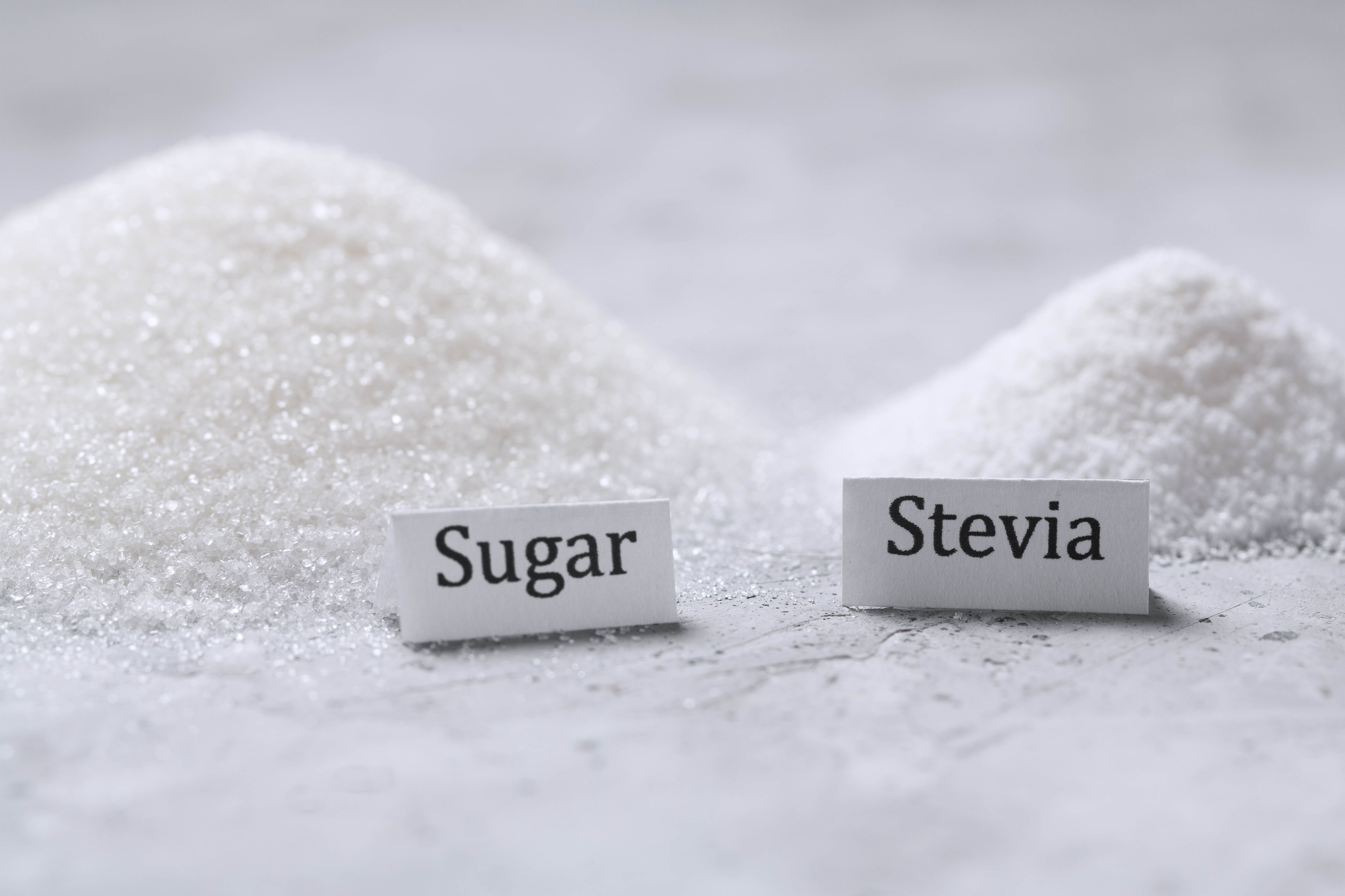 A pile of sugar and stevia sweetener with signatures